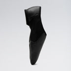 Black leather shoe on a light gray background