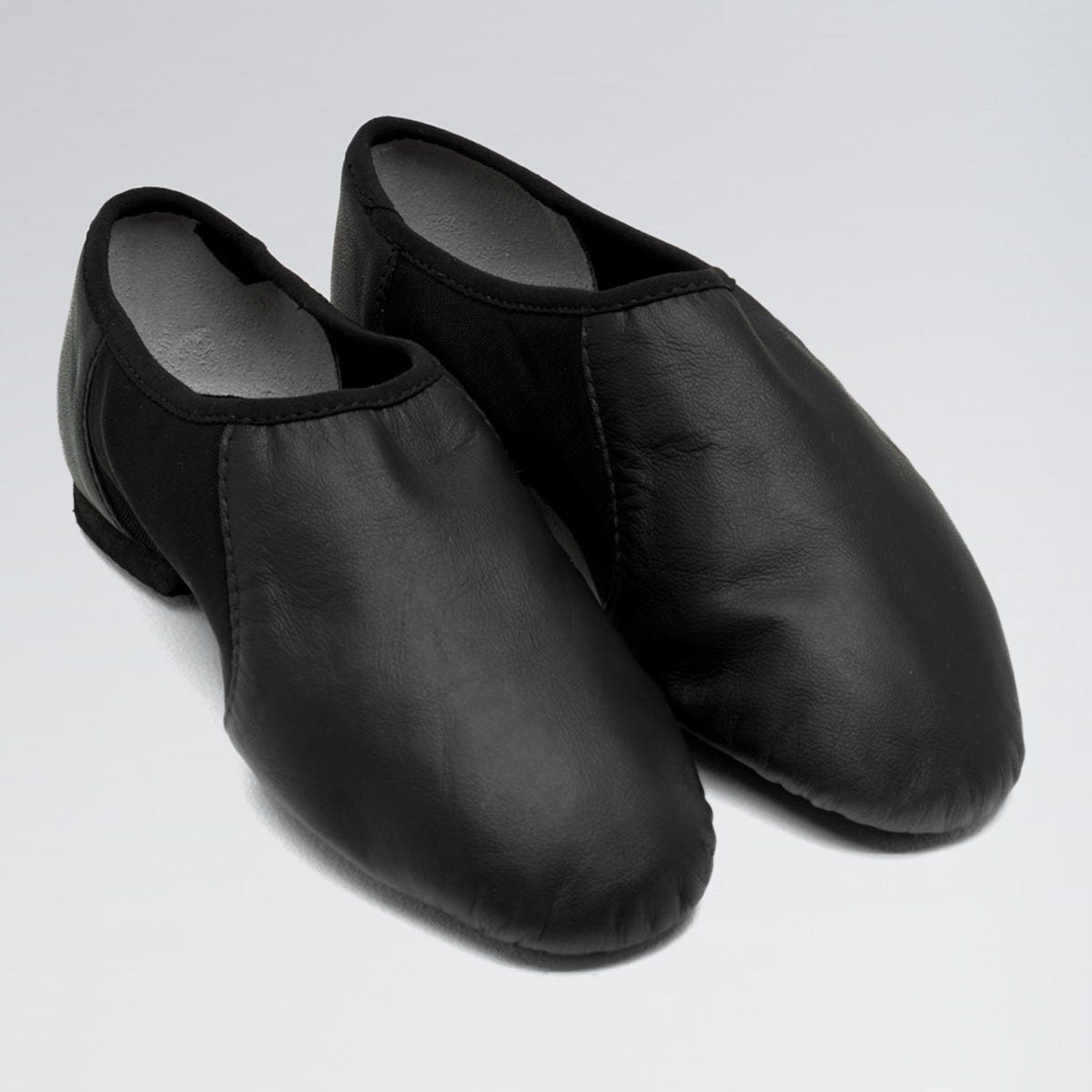 Pair of black leather shoes on a light gray background