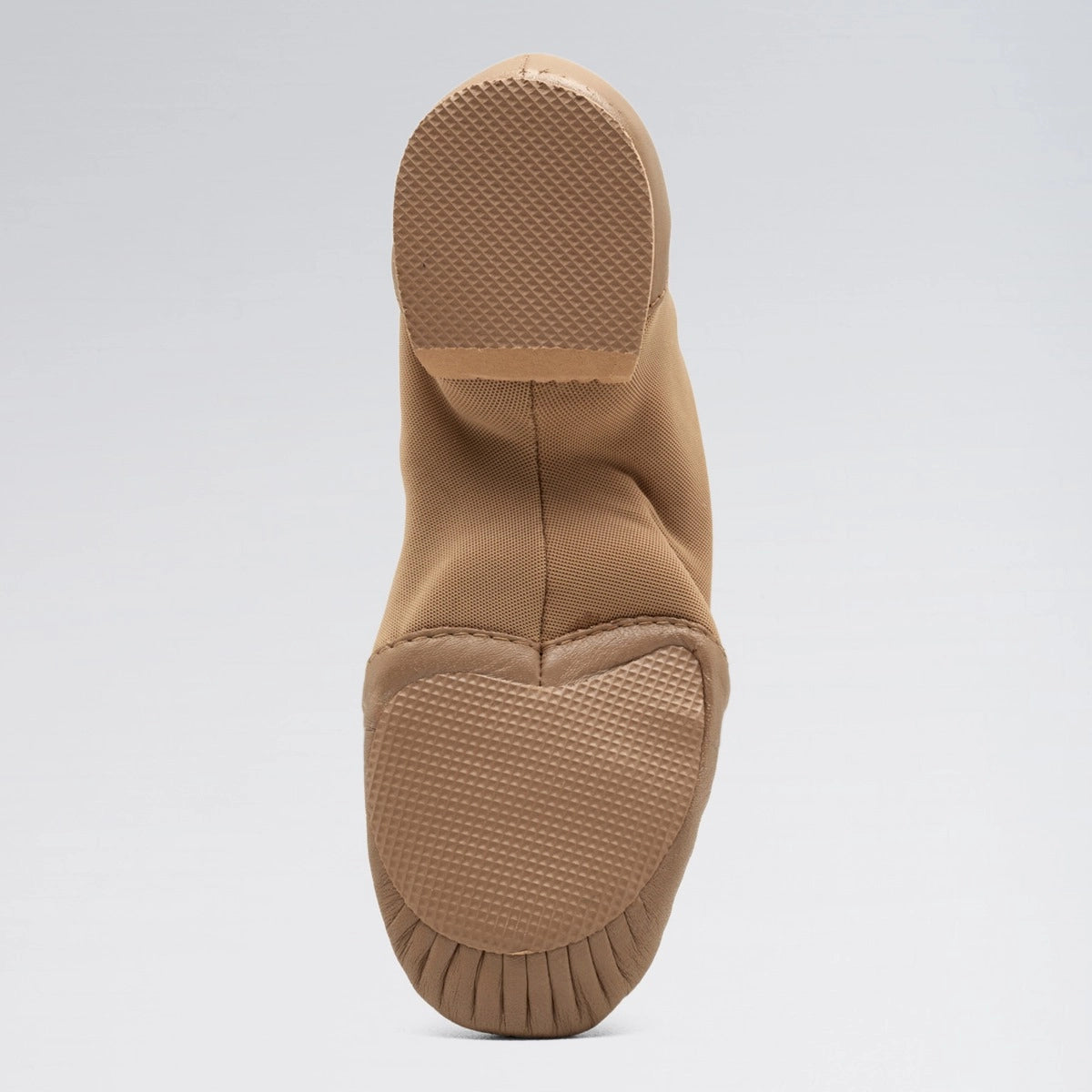 Tan slip-on shoe with sole on a light gray background