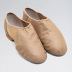 Pair of beige dance shoes on a light gray background