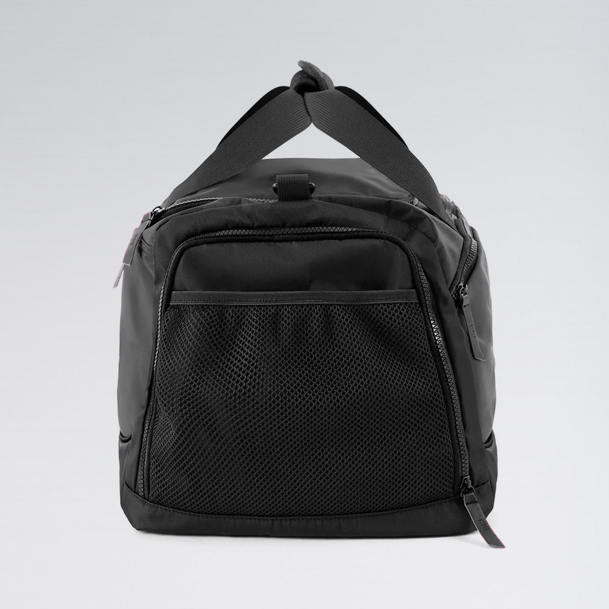 Black duffel bag on a light gray background
