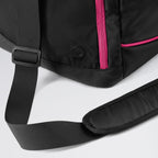 Black backpack with pink zipper on a light gray background