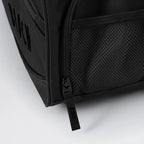 Close-up of a black backpack with zipper details on a light gray background