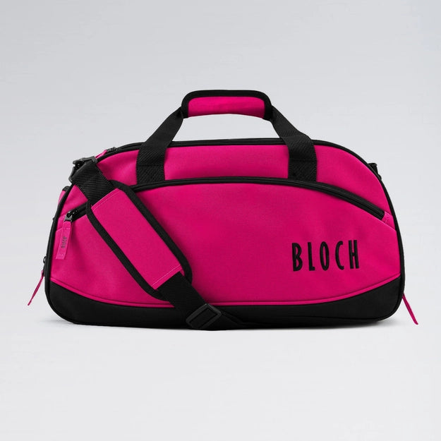 Pink duffel bag with black accents and 'BLOCH' branding on a light gray background