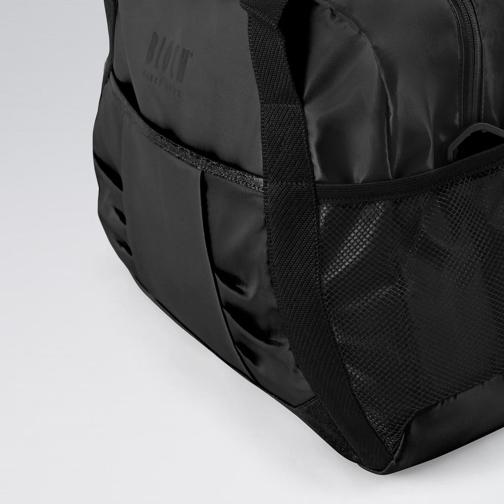Black duffel bag with visible brand logo on a light gray background