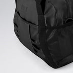 Black duffel bag with visible brand logo on a light gray background