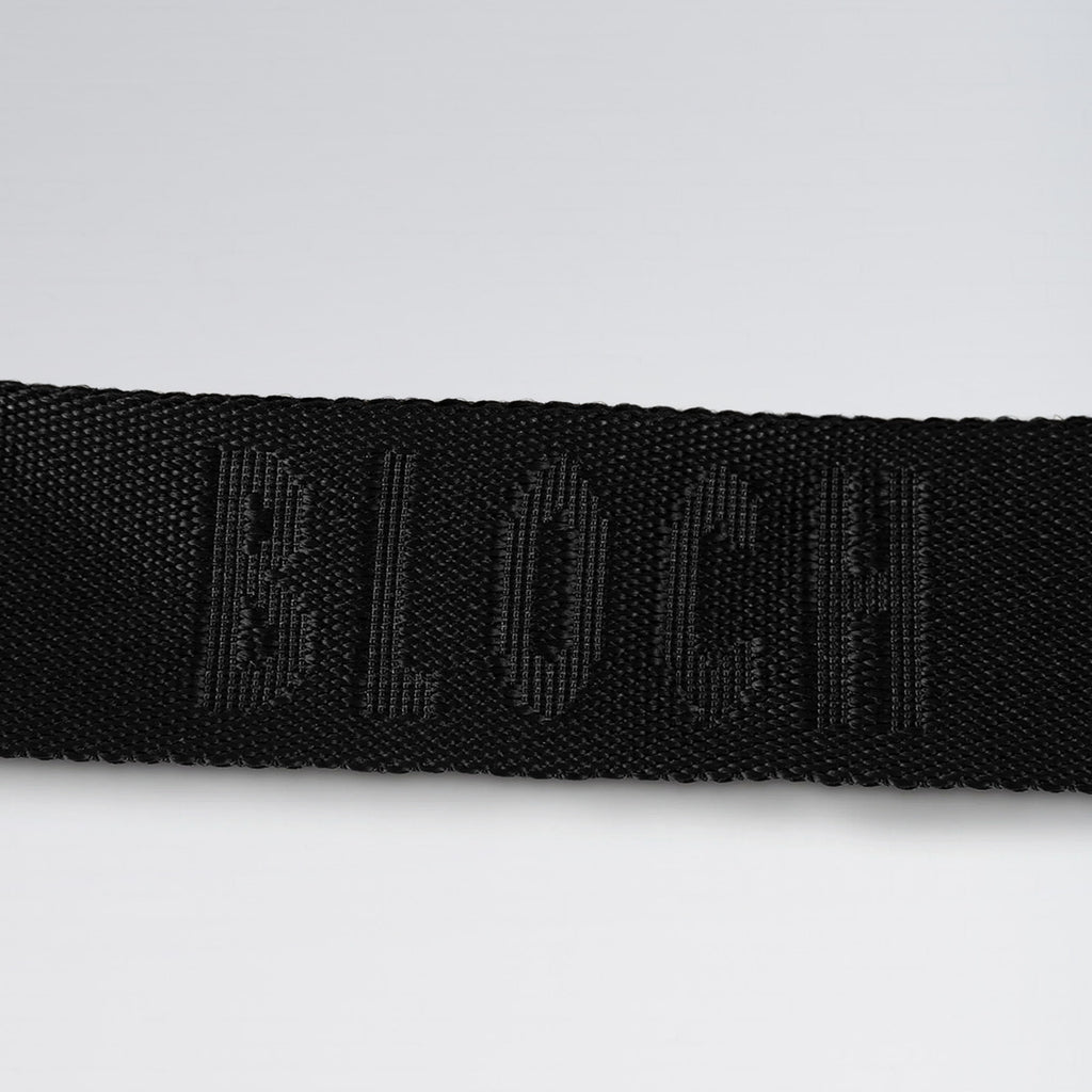 Black belt with a brand logo on a light gray background