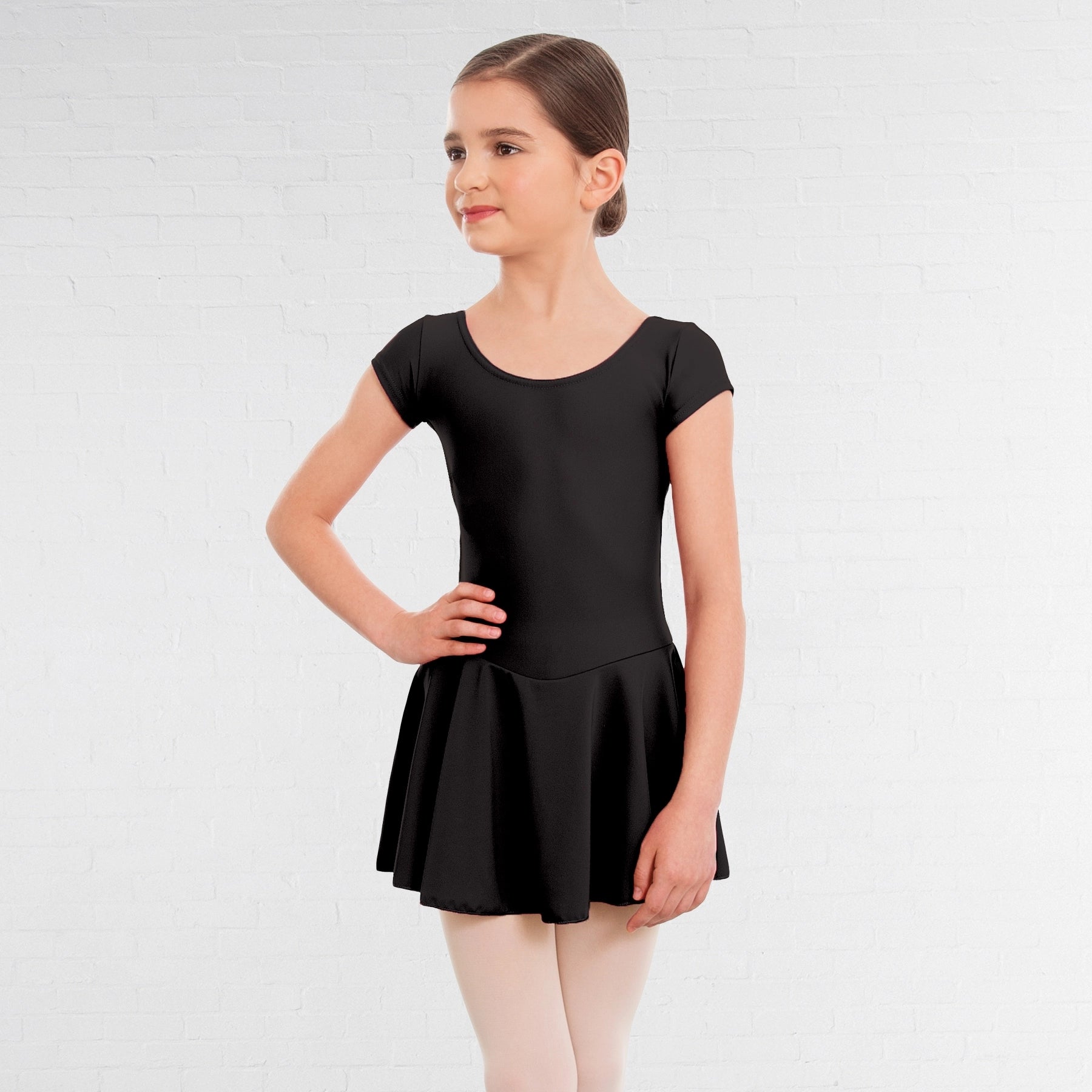 Young girl wearing a black leotard on a white background