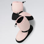 Pair of pink and black slippers with drawstring on a light gray background