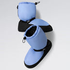 Pair of blue and black baby boots on a light gray background