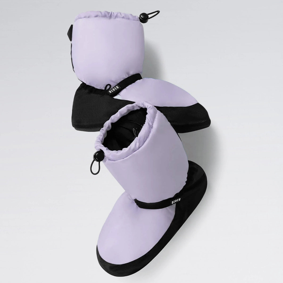 Pair of purple and black baby booties on a light gray background