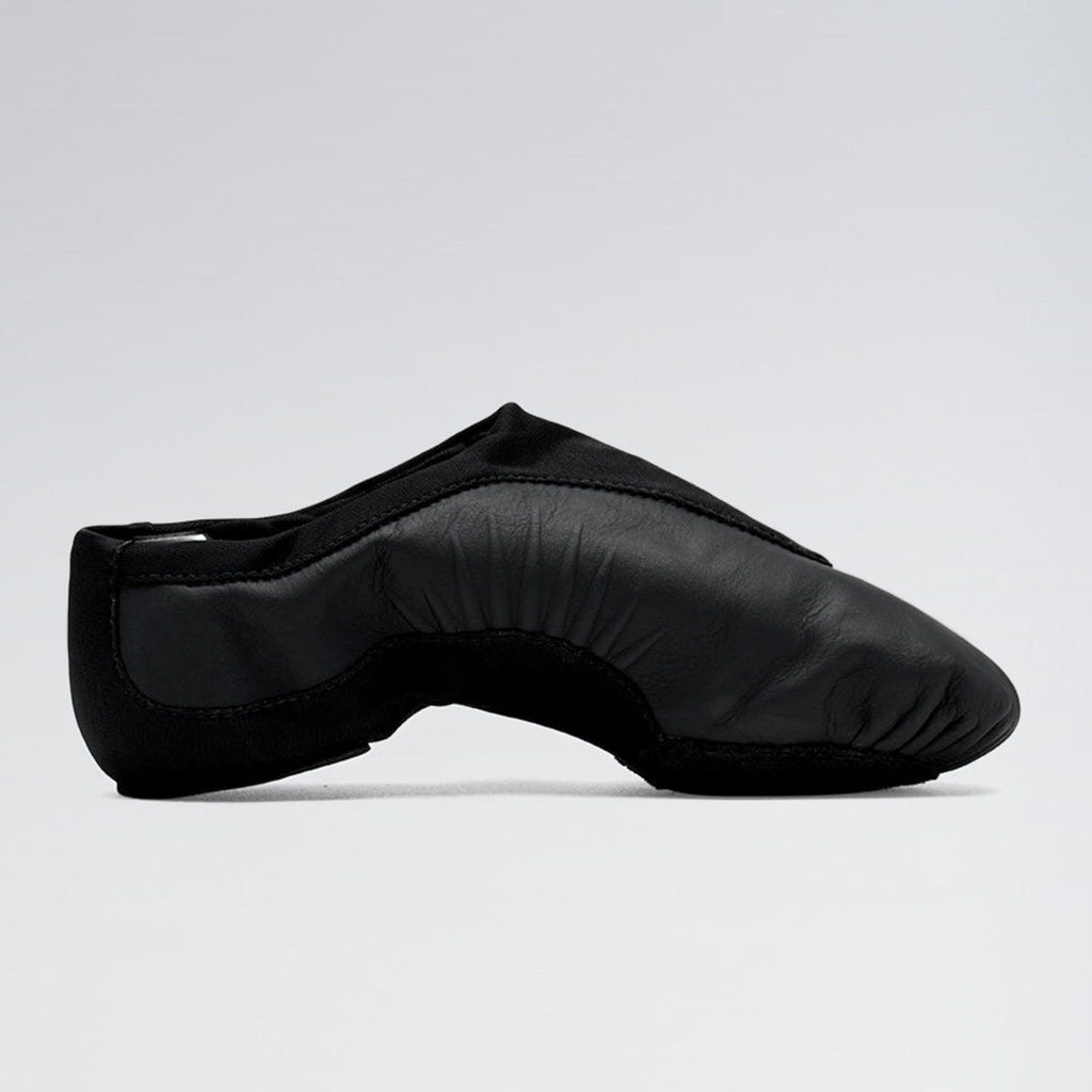 Black leather ballet shoe on a light gray background