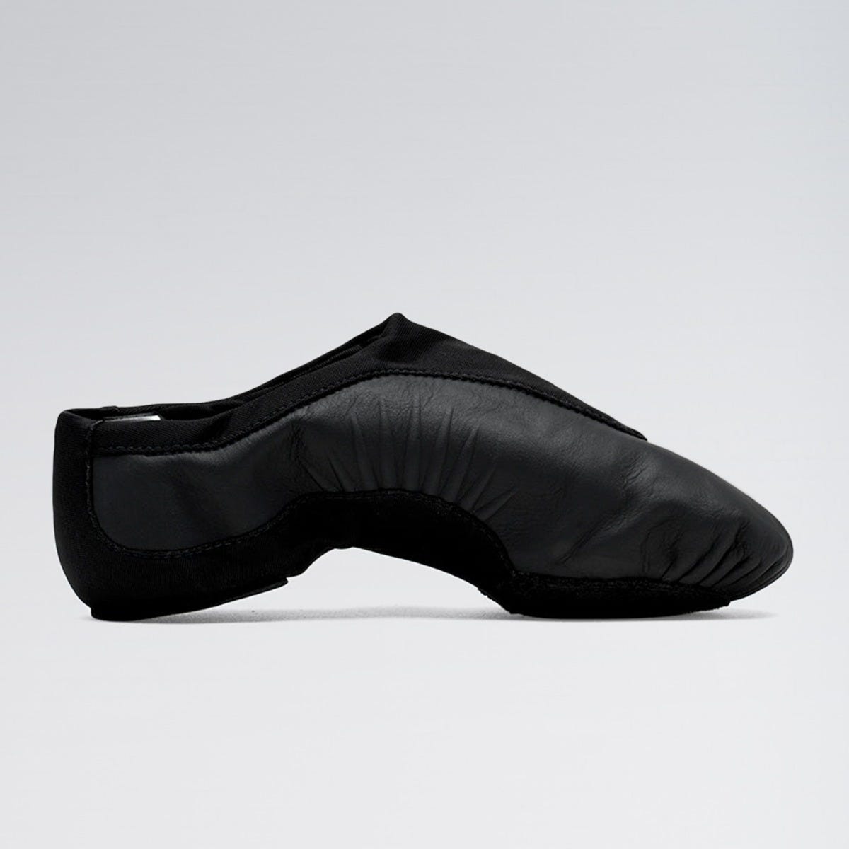 Black leather ballet shoe on a light gray background