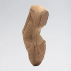 Tan ballet shoe on a light gray background