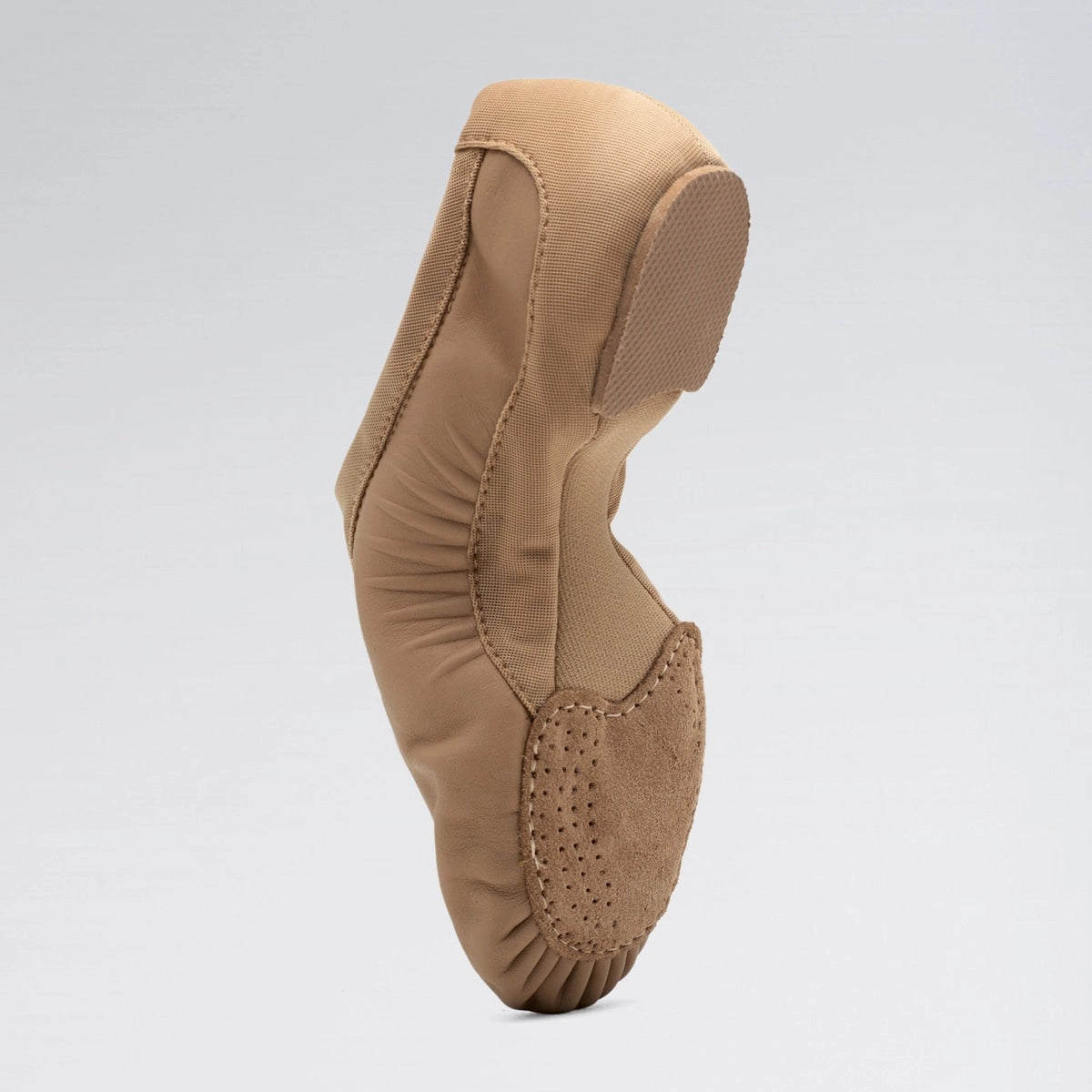 Tan ballet shoe on a light gray background