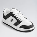 White and black sneaker with brand logo on a light gray background