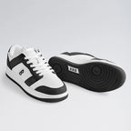 White and black sneakers on a light gray background