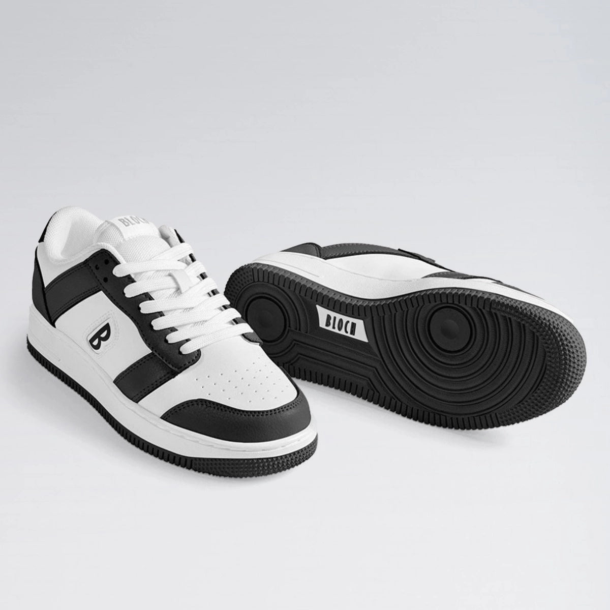 White and black sneakers on a light gray background