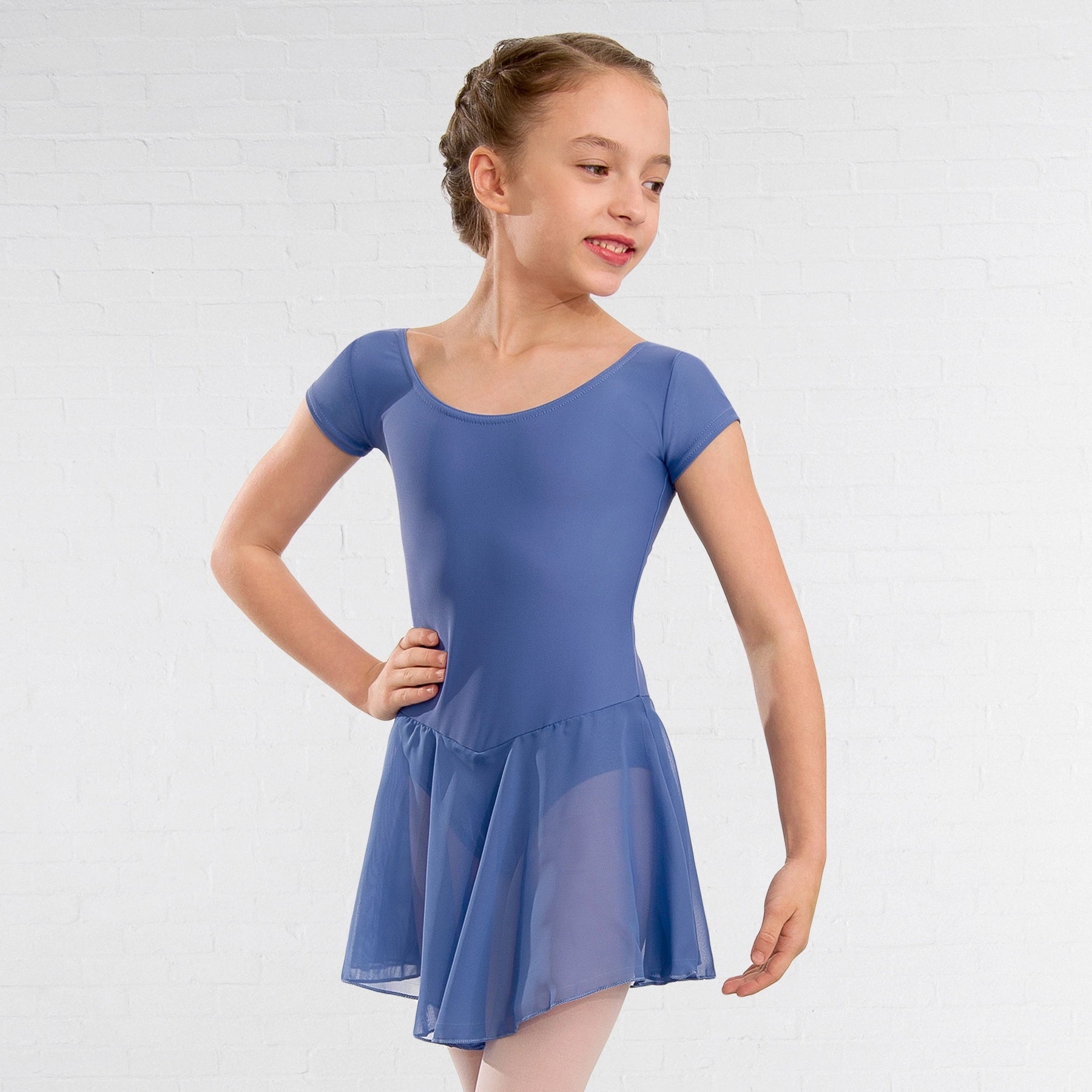 Young girl wearing a blue dress against a white background