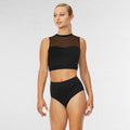 Woman wearing a black bikini with mesh panels on a white background