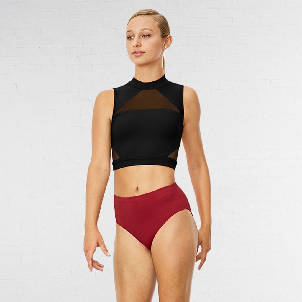 Woman wearing a black sleeveless top and red high-waisted bikini bottom on a white background