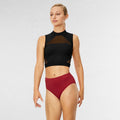 Woman wearing a black sleeveless top and red high-waisted bikini bottom on a white background