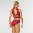 Woman wearing a red bikini set on a white background