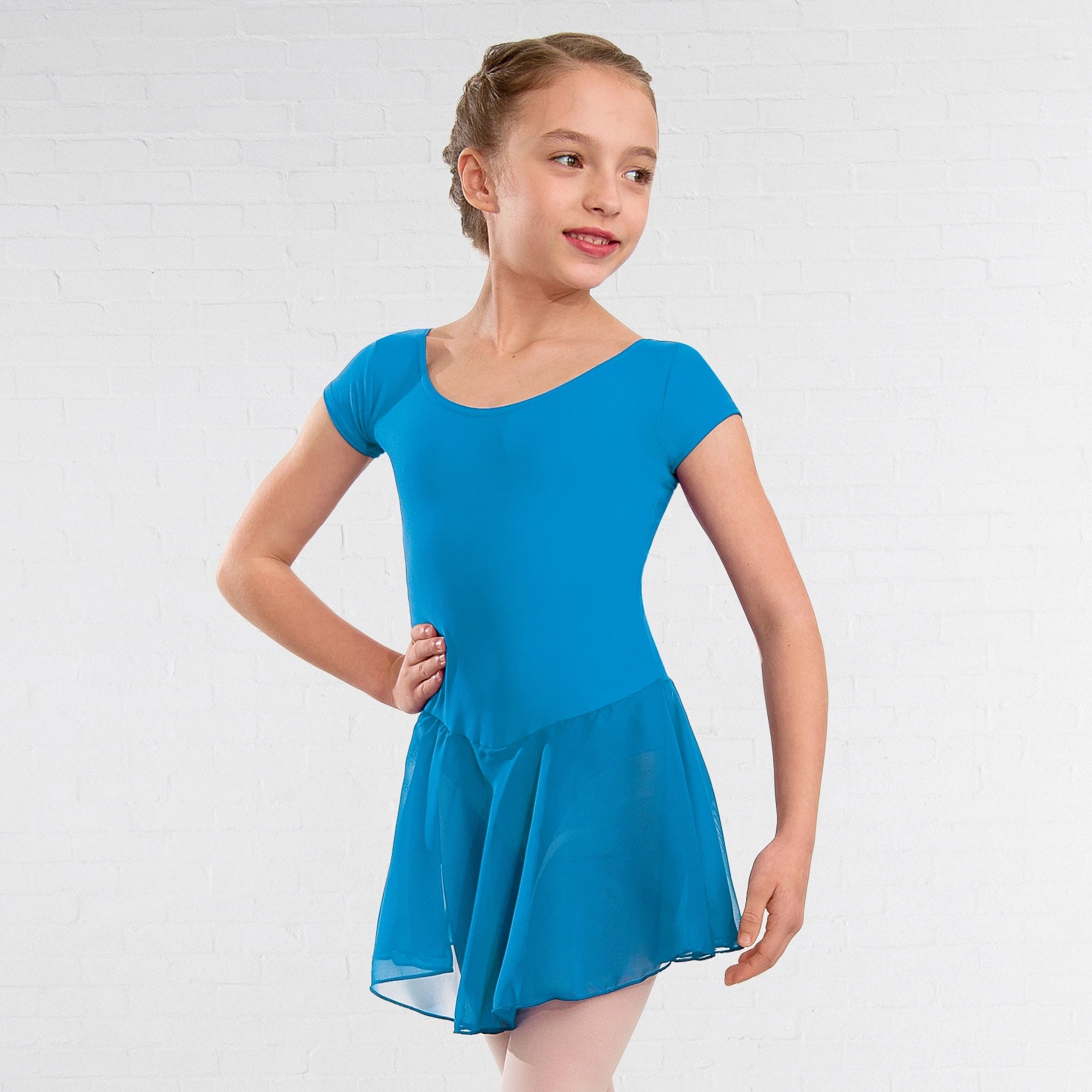 Young girl wearing a blue dress against a white background