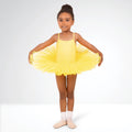 Young girl in a yellow tutu dress posing against a white background
