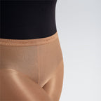 Close-up of beige shapewear with a black top on a light gray background