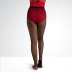 Person wearing red top and fishnet tights on a white background