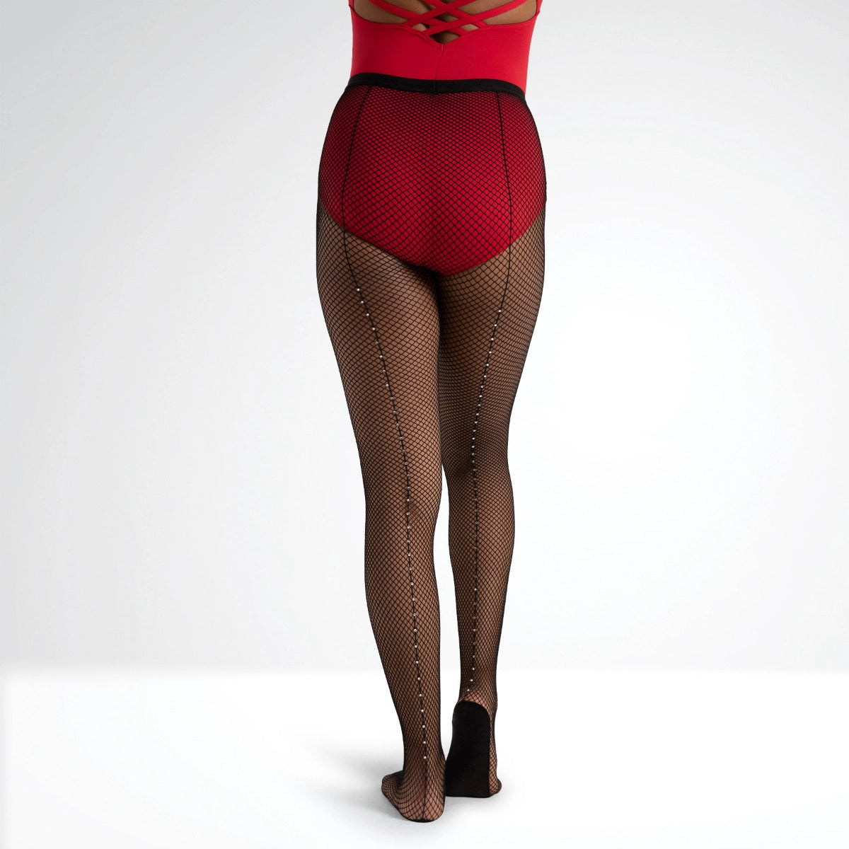 Person wearing red top and fishnet tights on a white background