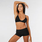 Woman wearing a black bikini set on a plain background