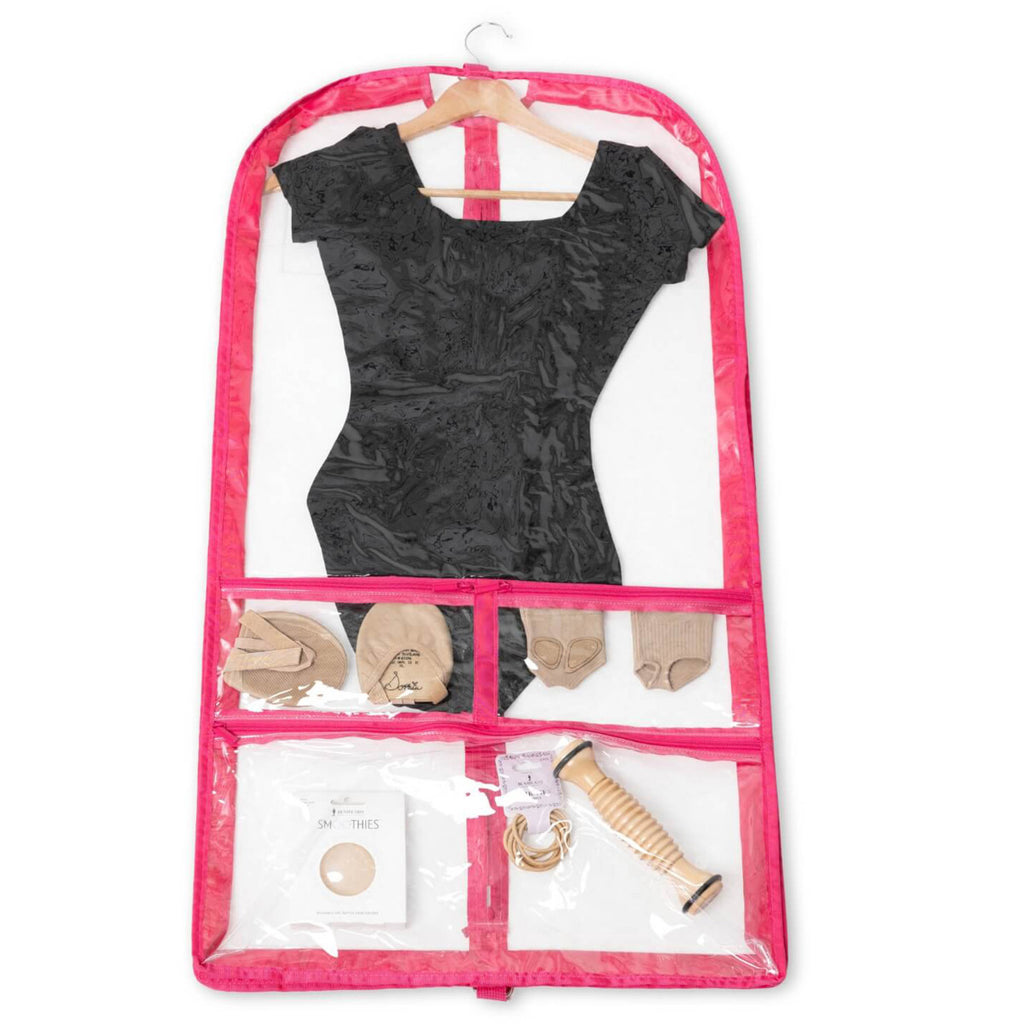 Clear garment bag with pink trim containing a black dress, shoes, and accessories on a white background
