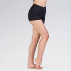 Person wearing black shorts on a plain background