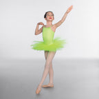 Ballerina in a green tutu posing against a white background