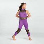 A young girl modeling a purple and black athletic two-piece set consisting of a sleeveless crop top and matching leggings, posed against a light gray studio background.