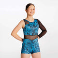 Person wearing a blue and black patterned leotard on a white background