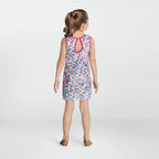 Girl wearing a colorful patterned dress on a white background