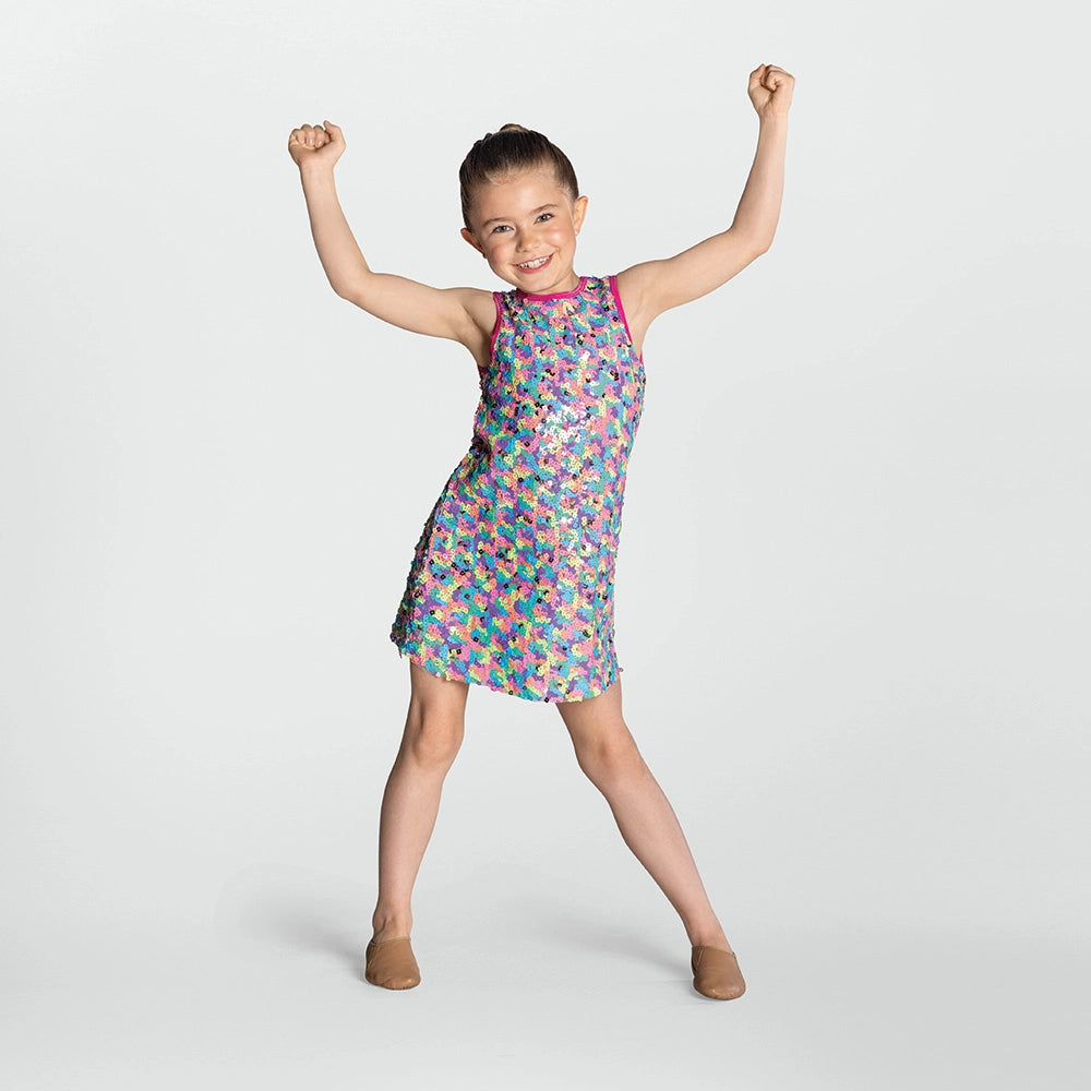 Child wearing a colorful dress with arms raised on a white background