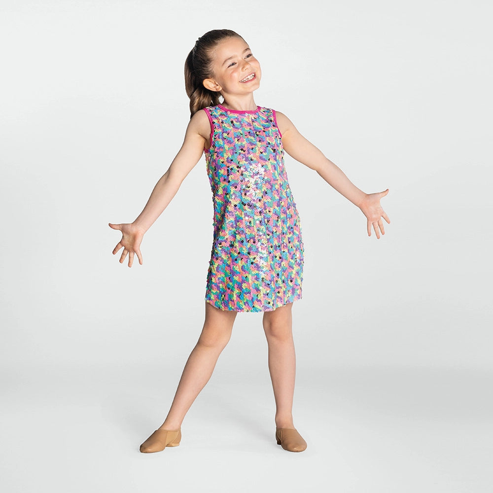 Young girl wearing a colorful patterned dress on a white background