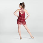 Woman wearing a red fringe dress on a white background