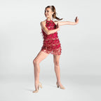 Woman in a red lace dress posing on a white background