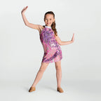 Young girl in a colorful dress posing against a white background