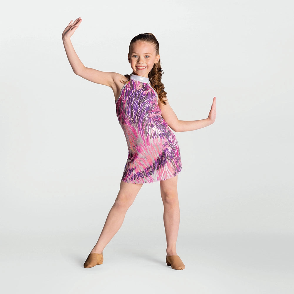 Young girl in a colorful dress posing against a white background