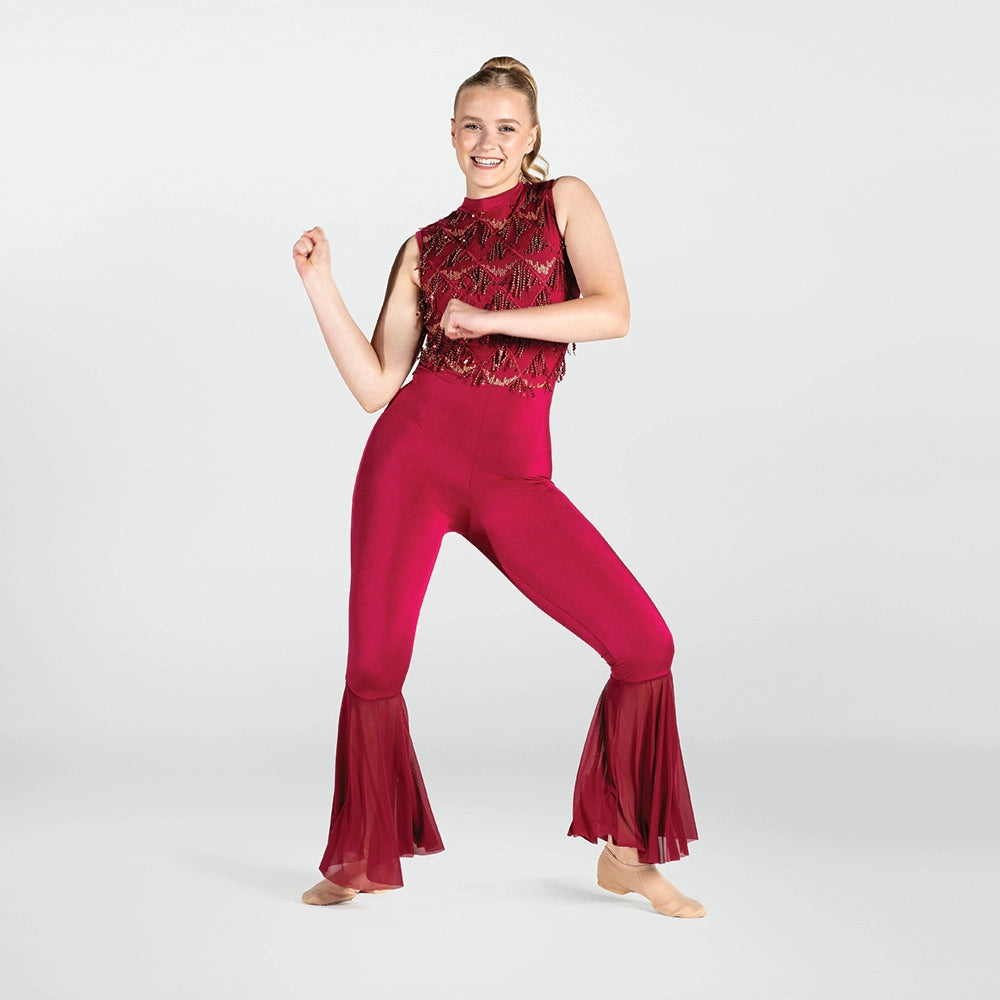 Person wearing a red jumpsuit with a sequined top on a white background