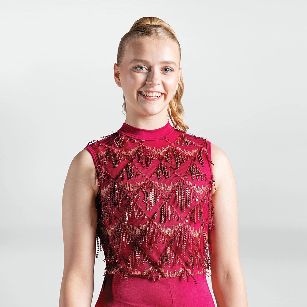 Woman wearing a red beaded dress against a white background