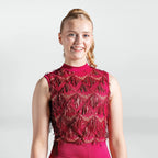 Woman wearing a red beaded dress against a white background