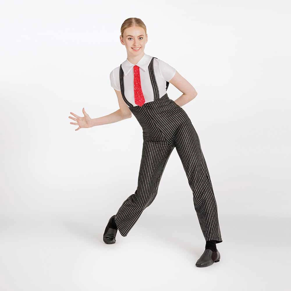 A woman modeling a black and white pinstripe costume jumpsuit with a white shirt, red tie, and black shoes against a plain white studio background.