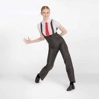 A woman modeling a black and white pinstripe costume jumpsuit with a white shirt, red tie, and black shoes against a plain white studio background.